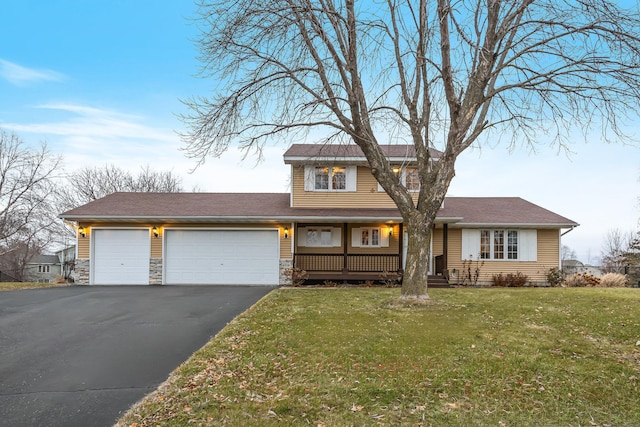 view of front of house with a front yard and a garage