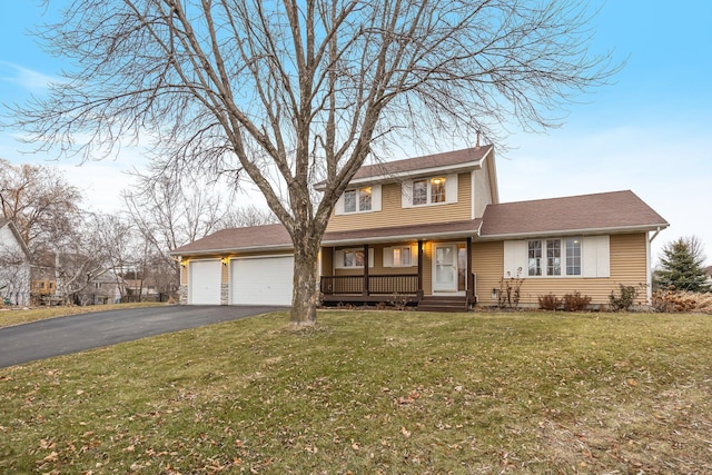 view of front of property with a front yard, a garage, and covered porch