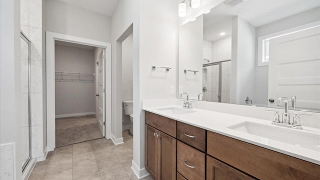 bathroom featuring walk in shower, tile patterned floors, vanity, and toilet