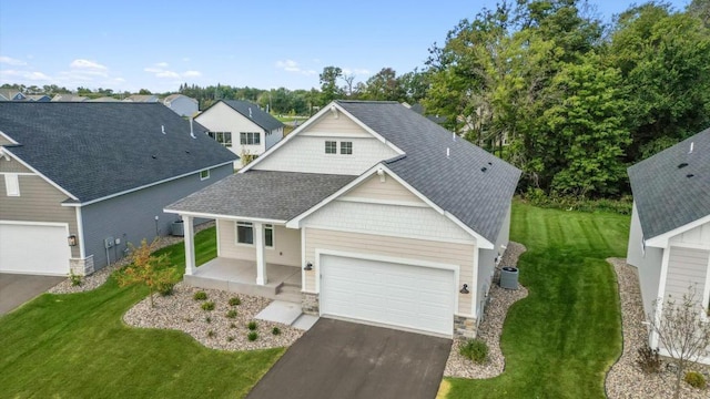 craftsman inspired home with a garage, covered porch, and a front yard