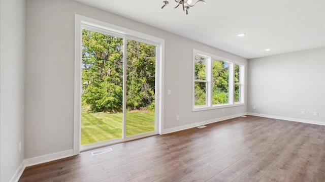 interior space featuring hardwood / wood-style floors and a chandelier