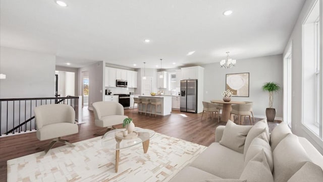 living room featuring recessed lighting, dark wood-style floors, and a chandelier