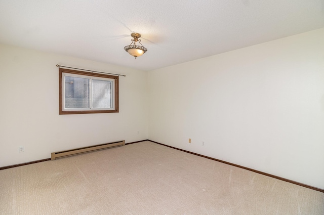 carpeted spare room with a baseboard radiator