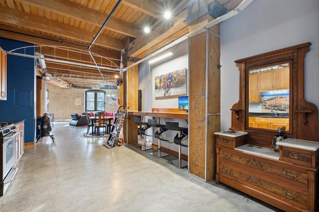 basement featuring wood ceiling and brick wall