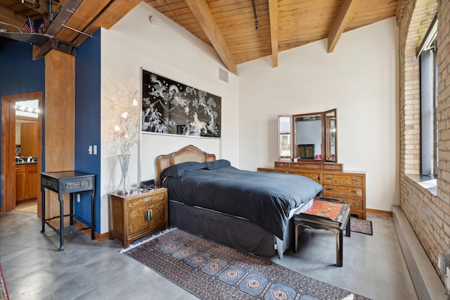 bedroom with beam ceiling, ensuite bath, wooden ceiling, high vaulted ceiling, and concrete floors