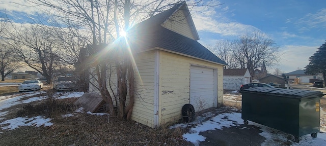 view of snowy exterior featuring a garage