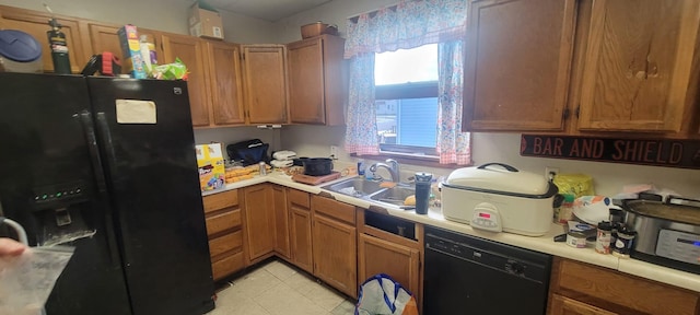 kitchen with black appliances, light tile patterned floors, and sink