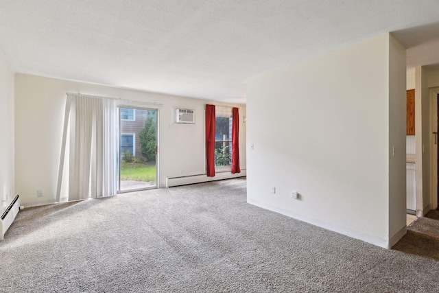 carpeted spare room featuring a textured ceiling and a baseboard heating unit