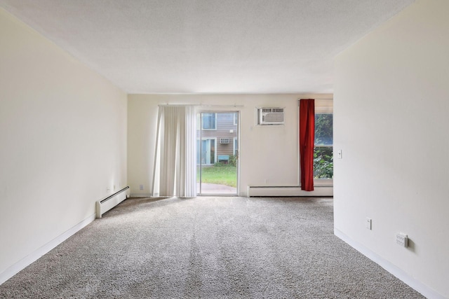 empty room with an AC wall unit, carpet floors, a baseboard radiator, and a textured ceiling