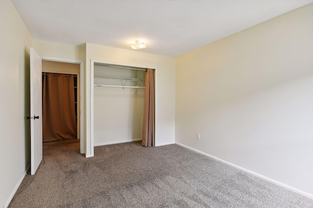 unfurnished bedroom featuring carpet flooring and a closet