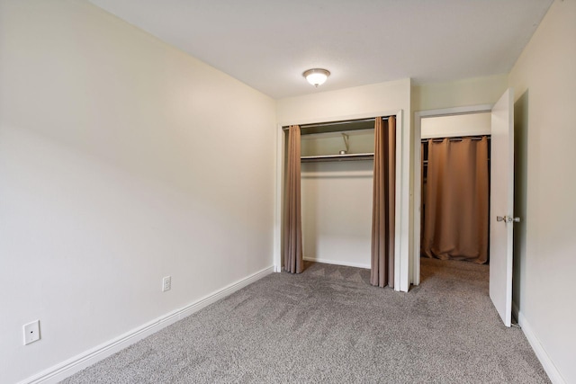 unfurnished bedroom featuring a closet and carpet