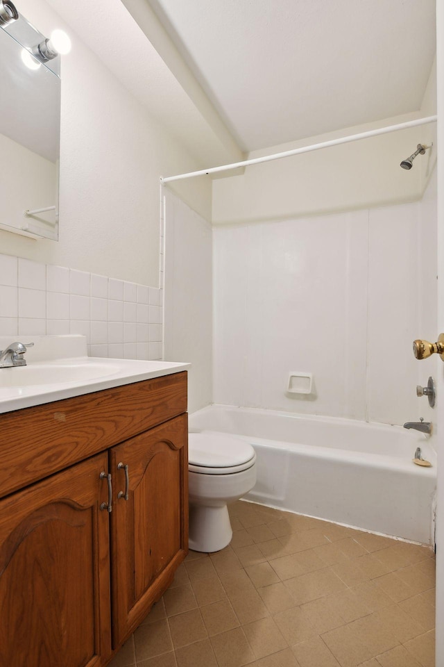 full bathroom featuring vanity, shower / washtub combination, tile patterned flooring, toilet, and tile walls