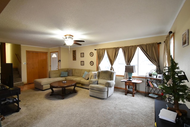 carpeted living room with ceiling fan and a textured ceiling