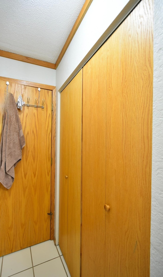 room details featuring ornamental molding and a textured ceiling