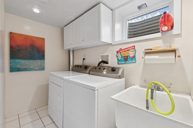 laundry room with cabinets, washing machine and dryer, sink, and light tile patterned floors