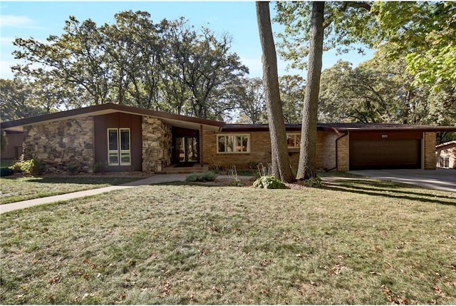 single story home with a garage and a front lawn