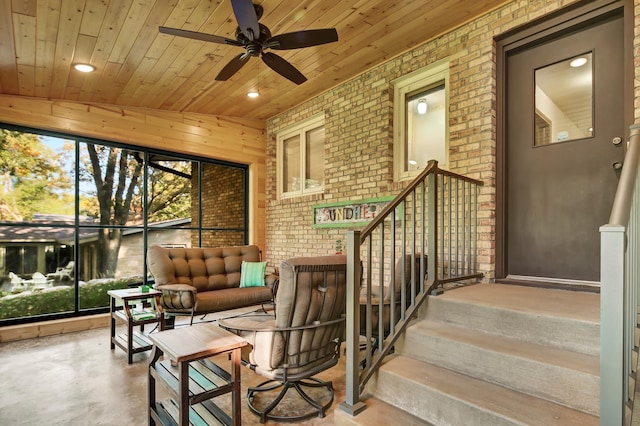 exterior space with lofted ceiling, wood ceiling, and ceiling fan