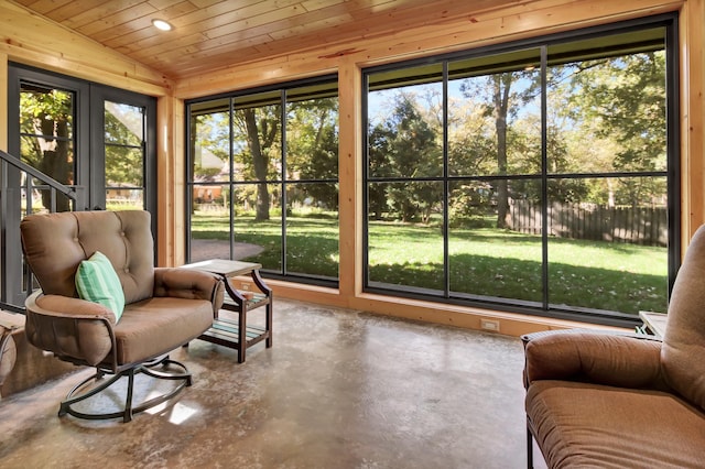 sunroom with a healthy amount of sunlight, vaulted ceiling, and wooden ceiling