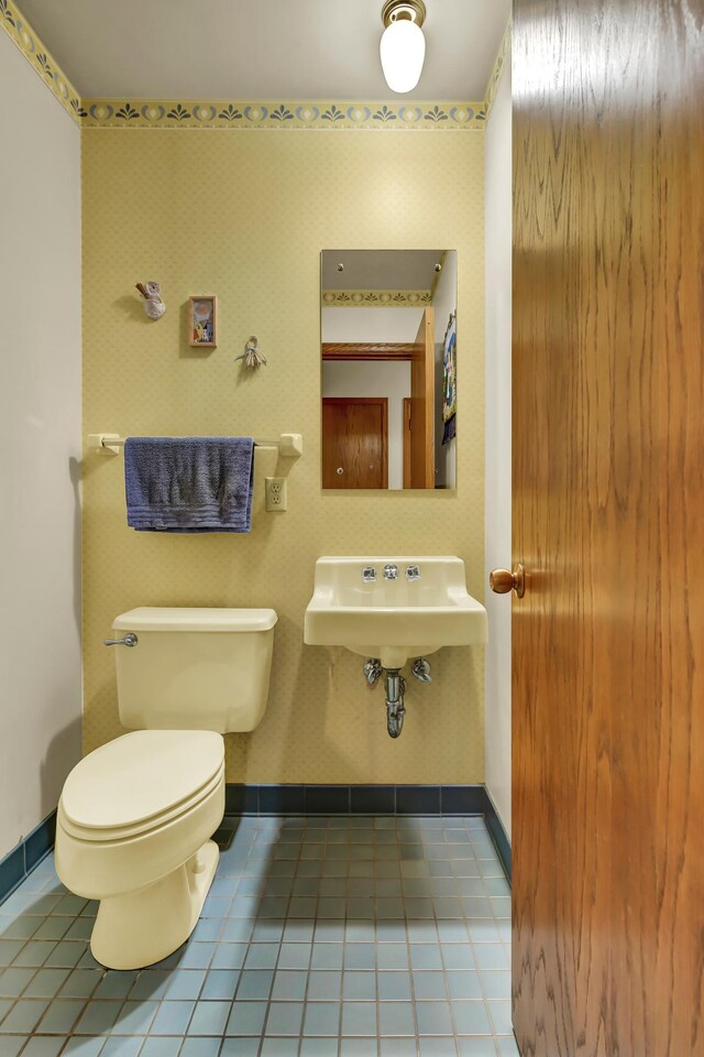 bathroom featuring tile patterned flooring, sink, and toilet