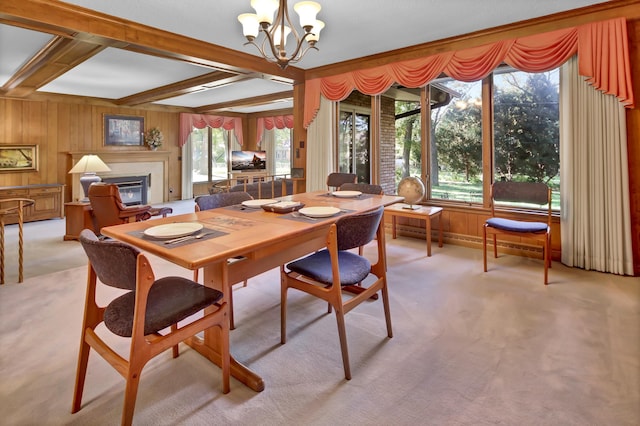 carpeted dining area featuring an inviting chandelier, wooden walls, and beamed ceiling