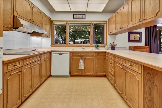 kitchen featuring sink, white dishwasher, tasteful backsplash, black electric stovetop, and kitchen peninsula