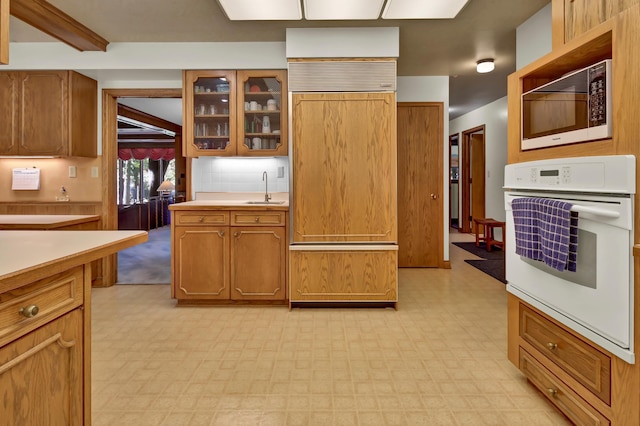 kitchen with built in appliances and sink