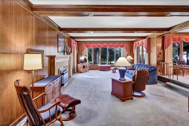 living room with wooden walls, light carpet, and beam ceiling