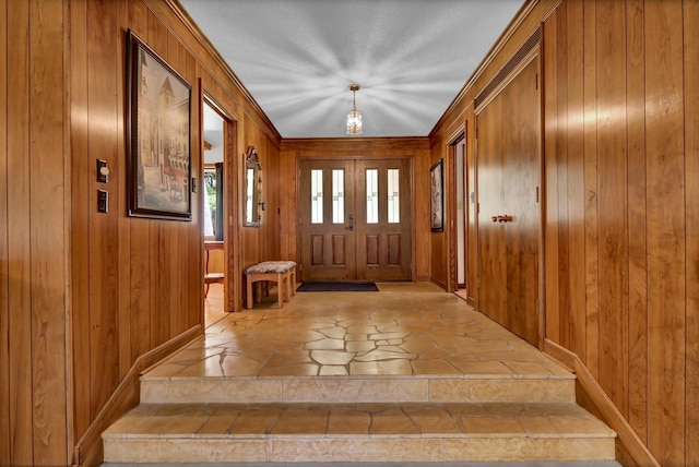 foyer featuring wooden walls