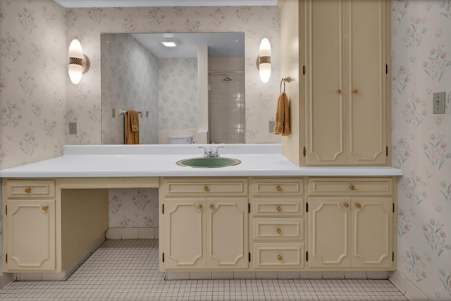 bathroom featuring vanity, tile patterned floors, toilet, and a shower