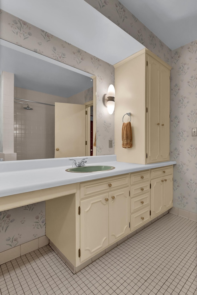 bathroom featuring vanity, tiled shower, and tile patterned floors