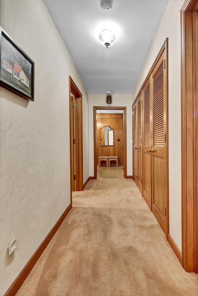 hallway featuring light colored carpet