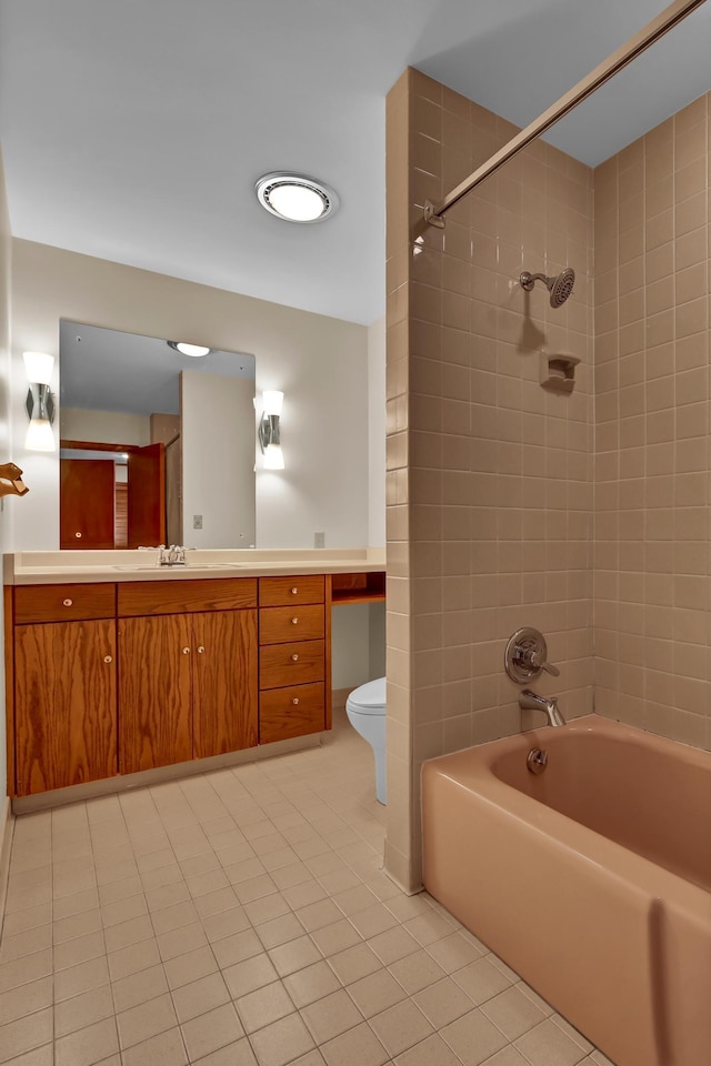 full bathroom with tile patterned floors, vanity, toilet, and tiled shower / bath combo