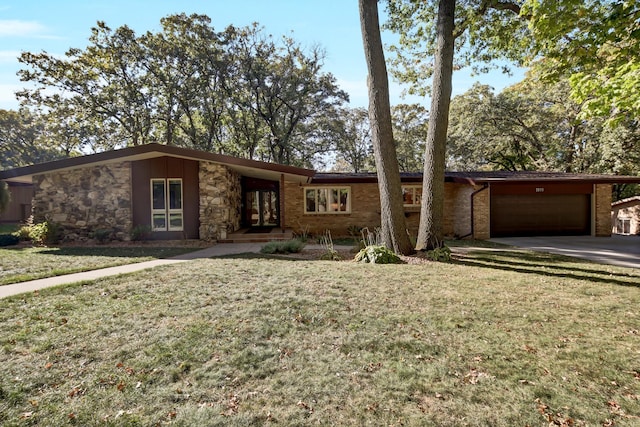 ranch-style home with a garage and a front yard