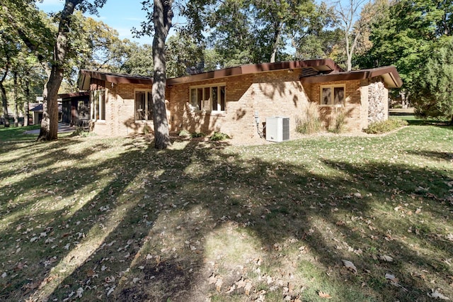 rear view of property featuring a lawn