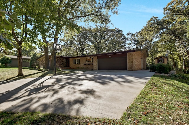 single story home featuring a garage and a front yard