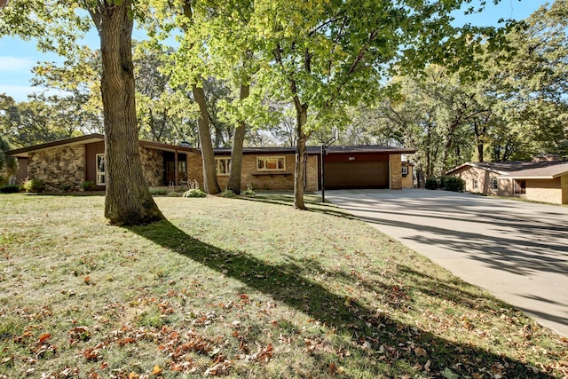 ranch-style home with a garage and a front yard