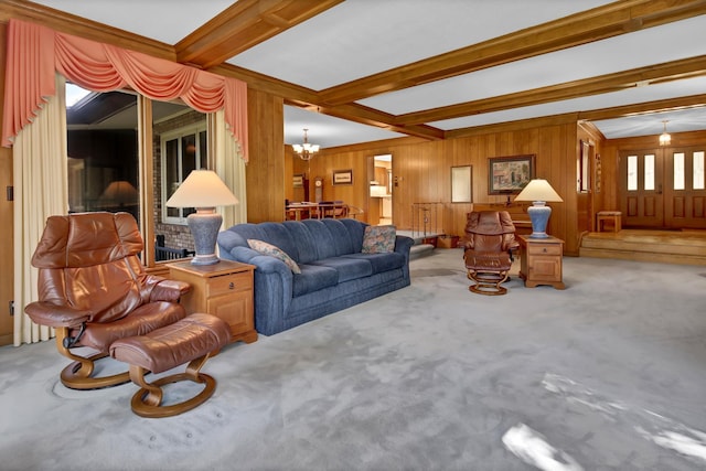 carpeted living room featuring beamed ceiling, wooden walls, and a chandelier