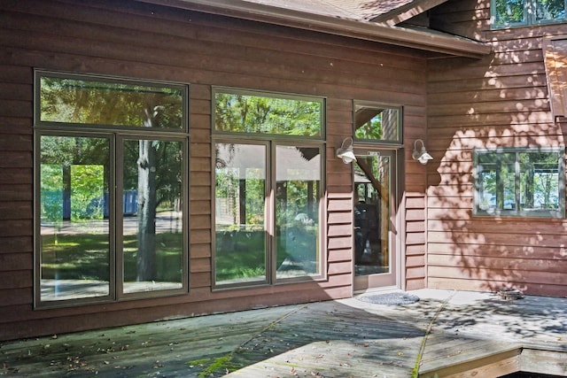 view of exterior entry featuring a wooden deck