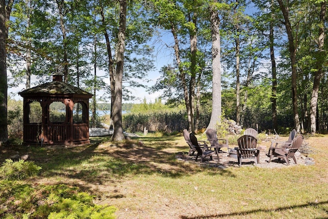 view of yard featuring a gazebo and a fire pit