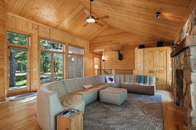 living room featuring light hardwood / wood-style flooring, high vaulted ceiling, ceiling fan, and wood ceiling