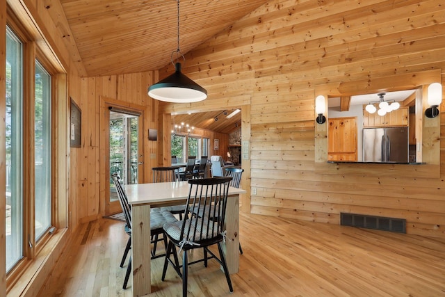 dining room with light hardwood / wood-style flooring, wooden ceiling, lofted ceiling, and a notable chandelier