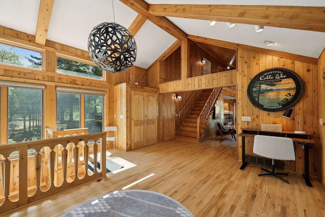 interior space featuring wood walls, beamed ceiling, high vaulted ceiling, and light wood-type flooring