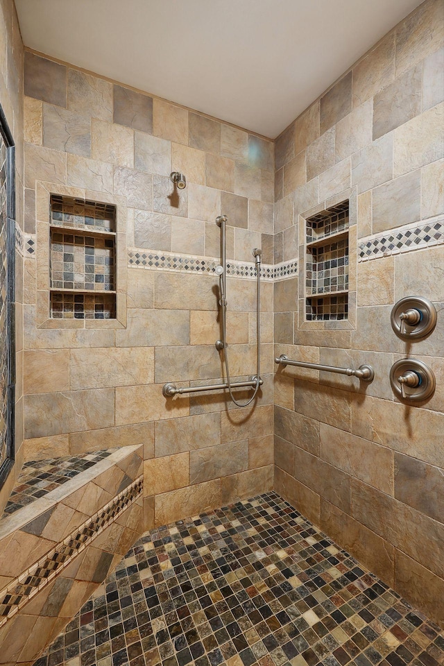 bathroom with a tile shower