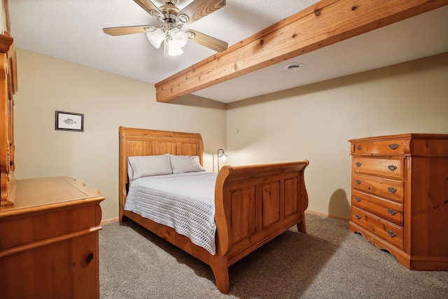 carpeted bedroom with beam ceiling and ceiling fan