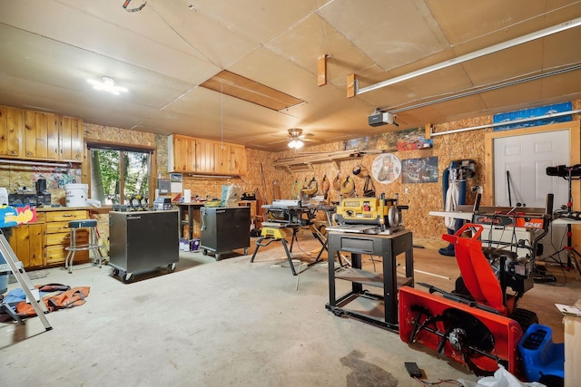 garage with a workshop area and ceiling fan