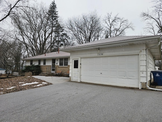 ranch-style home featuring a garage