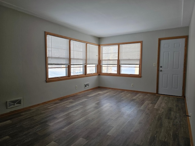 spare room featuring dark hardwood / wood-style floors