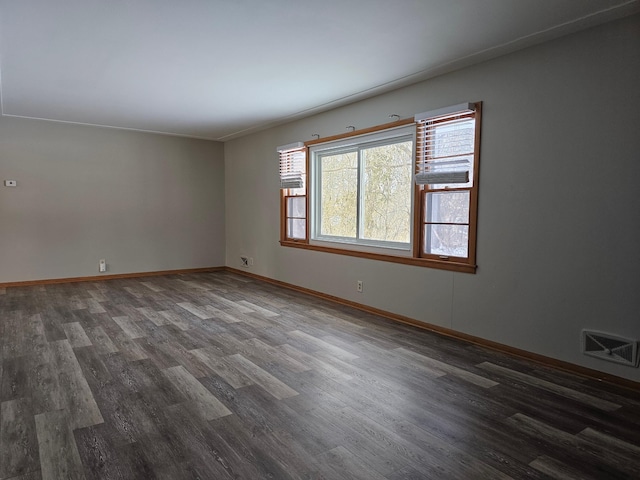 empty room with dark wood-type flooring