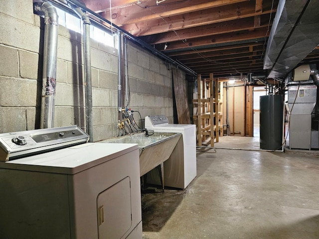 basement featuring heating unit, washer and dryer, and water heater