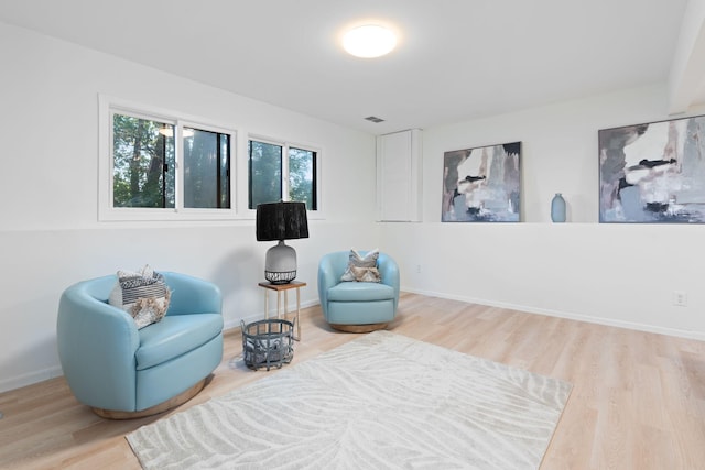 sitting room with wood-type flooring